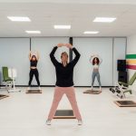 Group of women practicing pilates in an indoor gym in Yalova, Türkiye, promoting a healthy lifestyle.