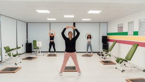 Group of women practicing pilates in an indoor gym in Yalova, Türkiye, promoting a healthy lifestyle.